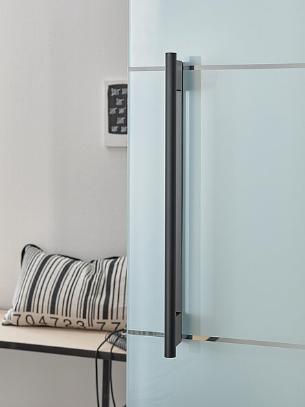 moderne Glasschiebetür mit langem Haltegriff